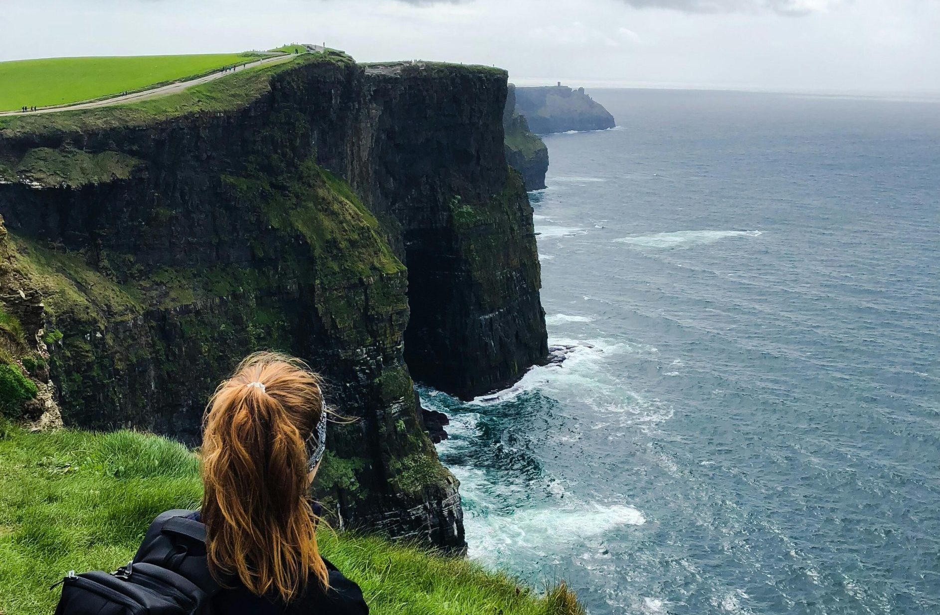 Tourist admiring the Cliffs of Moher