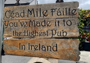Sign that reads "Welcome to the highest pub in Ireland"